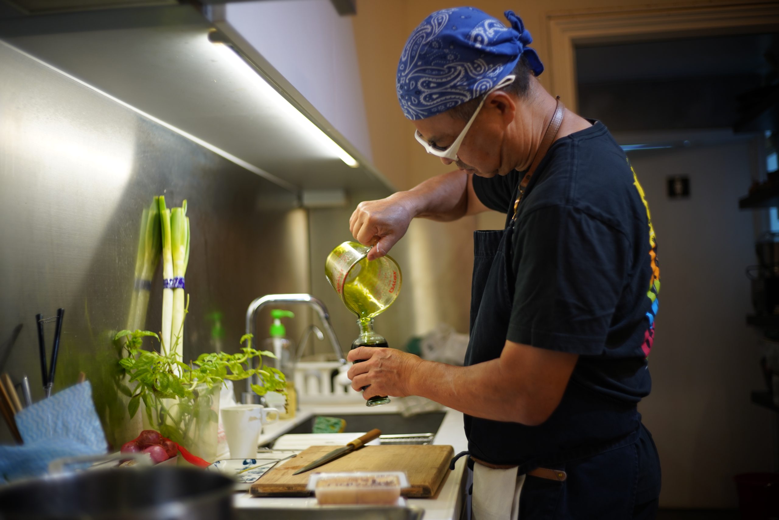Cook preparing organic vegetables in kitchen.